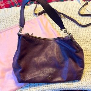 Kate Spade used bag- plum color. Lightly used.two stains as shown in pic